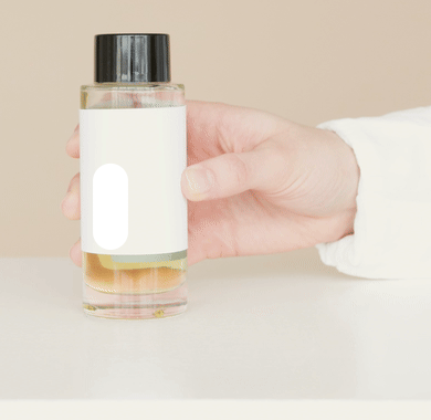 A paused cosmetic bottle frame with an intentional manual erasure and the same area restored from its original pixels